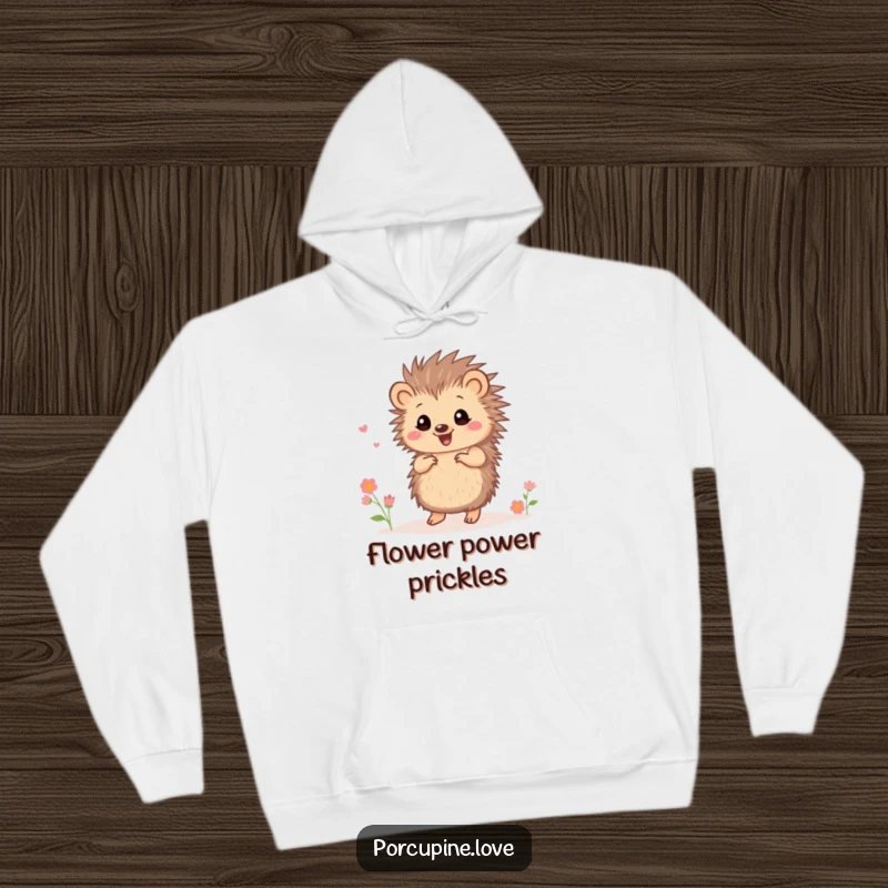 Funny small porcupine hoodie, dancing joyfully with tiny flowers, perfect for spreading cheer and warm comfort.